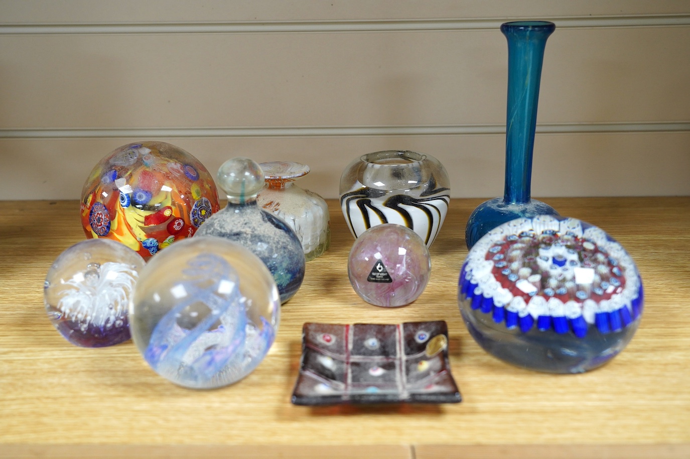 A group of glass paperweights, a vase and pin tray; Mdina, Murano, Isle of Wight etc. Condition - good